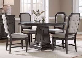 Crafted from acacia hardwood with mango wood veneers in a rich russet brown hue, the table features a fixed round tabletop and four chunky square legs, while a convenient lower shelf provides a perfect platform for cookbooks, table linens, or other tableside essentials. Carnaby Dining Table Set Gray