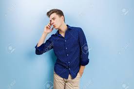 Guy says, bunch of yes men. Calm Thoughtful Handsome Dark Haired Guy Wearing Blue Shirt And Beige Pants Standing Against Blue Wall Stock Photo Picture And Royalty Free Image Image 107866265