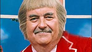 This nice man is using a trampoline to teach a kangaroo how to jump. (1960)