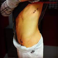 Simple Tiny Flying Birds Tattoo On Rib Cage Entertainmentmesh