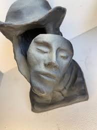 Sean Corner Sculpture, Floating Face in Bust.5 1/2”T X 5 1/2”D X 4 1/2 “W.  Black Small Specks of Color Loss See Photos.