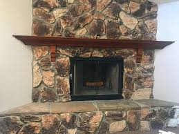 Add reclaimed wood mantle or something like this. Stone Fireplace Transformation From Dated To Modern A Happy Blog