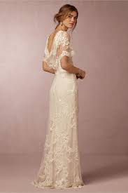 Estella Gown A Lacy Illusion Boatneck Flutter Sleeves And A Stunning Cowl Back Make This Delicate Short Sleeve Bridal Gown Bridal Gown Cheaper Bridal Dresses