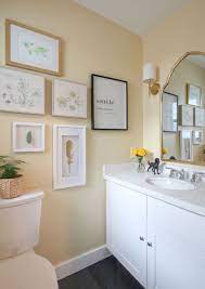 The powder room flaunts an elegant mirror over a strapping vanity; Kelly S Happy Yellow Powder Room Before After Yellow Bathroom Decor Bathroom Wall Colors Yellow Bathroom Walls