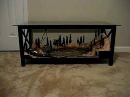 This coffee table layout includes backgrounds of mountains and buildings. This Would Be Perfect In The Living Room Chris Model Trains Model Train Table N Scale Coffee Table Layout