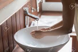 young woman bend over bathroom sink