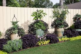 Add the rain boots to the fence in your child's area of the garden for them to grow their own flowers. Garden Ideas Along A Fence