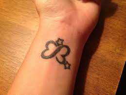 Kinda Looks Like An E And A B Perfect Would Get 2 Hearts Instead Of 2 Stars Tattoos Fairy Tattoo Heart Tattoo