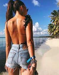 If you can draw your attention away from this woman's intoxicatingly beautiful eyes you'll notice her tribal inspired back and shoulder tattoo that. Lady Tattoo Spine Tattoos Women S Tattoo Elbow Tattoos