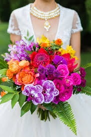 Your favorite blooms — from roses and peonies to lilies and daisies — send specific messages that you white ones signify purity, pink ones signify prosperity, red ones signify passion, orange ones signify pride, and yellow ones signify gratitude. This Bridal Bouquet Is Gorgeous All Of The Flower Colors Together Red Pink Orange Yellow And Purple Are Stu Bridal Bouquet San Diego Style Wedding Flowers
