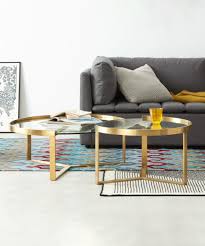 A pretty modern coffee table with 4 nesting stools having rectilinear grey frames of wooden materials. Aula Nesting Coffee Table Brushed Brass And Glass Made Com