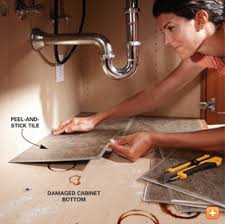 Place old towels over the bottom of the cabinet to sop up excess water. Clever Fix For Worn Out Cabinets Underneath The Sink Diy Bathroom Storage Home Repairs Stick On Tiles