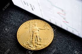 closeup of golden american eagle coin with a chart reflection