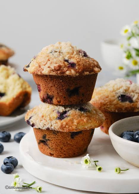 Bakery-style blueberry muffins with tall, golden tops, AI generated