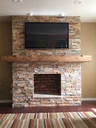 Historic mantels jordana stone mantel's sweeping soft curves and classic design blur the lines between art and function. Stone Fireplace With Wrap Around Barn Beam Mantel House Brick Fireplace Airstone Fireplace Fireplace Remodel