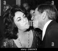British-American actress Elizabeth Taylor and Baritone Robert Merrill greet  each other at a reception at the Waldorf-Astoria in New York, United States 