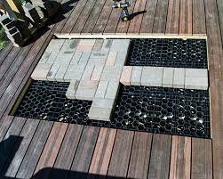 Natural stone kontiki interlocking deck tile s are gray and measure one square foot; Elevated Deck Solutions