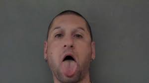 Burglary, trespassing suspect takes odd mug shot