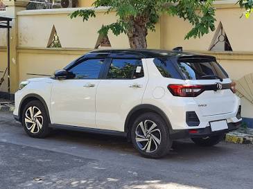 Side view of the 2022 Toyota Raize SUV in White Pearl and Black Roof layout., AI generated