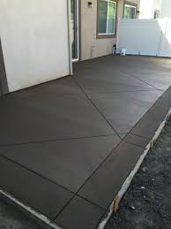 Colored Concrete With Diagonal Joints And Washed Bands Create A Large Feel In Small Spaces Concret Concrete Backyard Concrete Patio Designs Concrete Patio