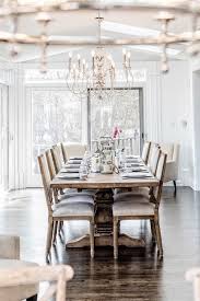Stylish dining room with a linear chandelier and a charming dining set that sits across the rustic console table topped with candles and white table. 20 Farm Table Dining Room Magzhouse