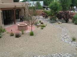 In some cases, digging a small ditch to direct the waterflow away from your fire pit can completely eliminate the problem. Xeriscape Backyard W Flagstone Fire Pit Dry River Bed For Drainage Control Garten Albuquerque Von Gecko Landscaping Inc