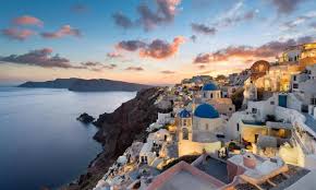 This lovely blue house features a metal roof, a lovely front porch, and an outside seating area covered by the towering trees. The Place With White Houses And Blue Roofs Crowdink