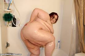 Ugly overweight woman Demisis poses naked in the bathroom and takes a shower