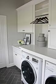 White Laundry Room With Gray Herringbone Floor Tiles Transitional Laundry Room White Laundry Rooms Grey Laundry Rooms Laundry Room Flooring