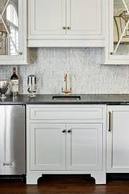 Black traditional kitchen cabinets can be a delightful choice for spacious rooms with lots of natural light. Black Marble Countertops With White Cabinets Transitional Kitchen