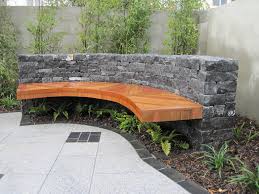 Built In Wooden Curved Garden Bench Hung Invisibly From A Limestone Rock Wall Garden Seating Garden Bench Backyard Patio Designs