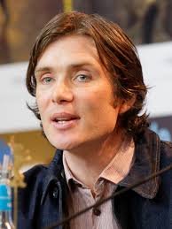 He wears a dark suit, a white shirt with a grey tie, grey socks and black shoes. Cillian Murphy Wikipedia
