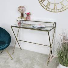 The console table is emphasised by its geometric shape and modern style. Gold And Glass Metal Desk