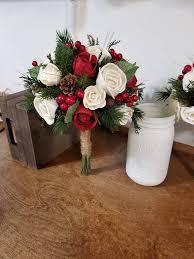 Poinsettias are an evident flower choice for a christmas themed wedding, but you can use red and white roses or holly instead of ivy or other greenery. Wedding Bouquet Winter Red Pine Bouquet Sola Bouquet Red Etsy Red Bouquet Wedding Winter Bouquet Christmas Wedding Bouquets