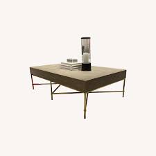 The organically inspired square tray top sit on minimalist style iron base with a warm gold finish. Williams Sonoma Faux Shagreen Coffee Table Aptdeco
