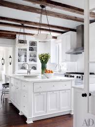 Inspiration for a modern galley light wood floor and beige floor open concept kitchen remodel with an undermount sink, natural wood kitchen cabinets, light wood cabinets, white backsplash, white marble countertops, stainless steel appliances and a peninsula. 29 Rustic Kitchen Ideas You Ll Want To Copy Architectural Digest