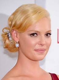 For a flattering updo that's young and feminine, keep the part undefined, the volume under control and focused in the back, and the pieces loose and random. Katherine Heigl Beauty Riot