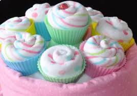 The trick is to try to decorate the cupcakes to match your theme. Washcloth Cupcake Instructions Homemade Baby Shower Favors Baby Shower Crafts Baby Shower Diaper Cake