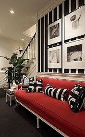 It is the red sectional placed in a grey, white, and black living room theme. Love The Black White Styled Entry Made Extra Fab By The Gorgeous Red Sofa Rachellabelle Interiors Home Interior House Interior