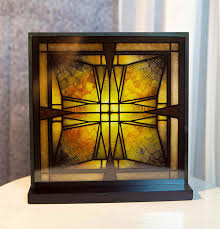 The combination of that gallery wall and the dark accent wall is absolute perfection to me. Corrigan Studio Frank Lloyd Wright Thomas House Entry Ceiling Light Wall Decor Wayfair