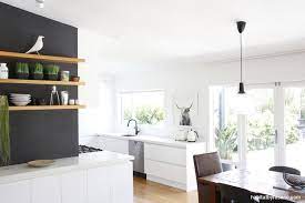 The light and airy kitchen is painted in resene black white, with trims in resene alabaster. Resene Double Alabaster Provides The Perfect Neutral For This Devonport Home The Garden Is In Full Vi White Dining Room Purple Kitchen Dining Room Inspiration