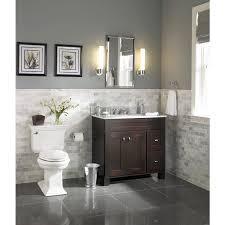 Marble flows from the countertop to the walls and floors, both inside this master bathroom is a mix of tan paint and beige tile. Bathroom Vanity Tile Ideas