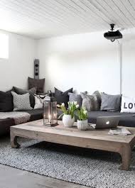A marble coffee table, a wooden tray with beads, a vase with greenery, some candles and books and a pumpkin. An Entry From When Life Gives You Lemons Living Room Scandinavian Living Room Grey House Interior