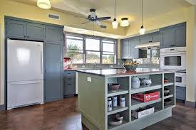 Dusty Blue Cabinets And A Sage Green Kitchen Island Complement The Pale Yellow Walls In This Lovely Country Kitche Country Kitchen Kitchen Colors Blue Cabinets