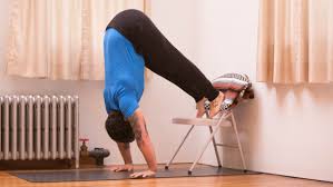 First sit on the floor and get your arms and push into a handstand mode but with your head on the ground try to straighten your legs up and then come back down. Use A Chair To Progress Toward A Handstand Press