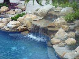 Waterfalls bring us closer to nature and ricorock inc. Rock Waterfall And Pond Into Swimming Pool Contemporary Pool Miami By Matthew Giampietro Garden Design