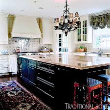 The backsplash contains squared, cream travertine tiles from kitchen hood to the kitchen's countertop. French Kitchen Blue White Tile Backsplash The Glam Pad