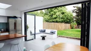 For a larger area, a round coffee table or square coffee table can fill empty space and balance out the dimensions of the room. Bi Fold Doors With Outdoor Seating Lovely House Extension Design Bifold Doors Onto Patio Sliding Patio Doors
