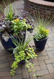 Your faux flower arrangements won't require you to cut stems, change water, or clean up dry and wilted petals. Flower Arrangement In A Pot Flower Pots Outdoor Flower Pots Patio Flowers
