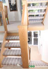 Open Tread Striped Stairs With A Wider Chamfered Newel Post And Glass Balustrade Carpet Stairs Newel Post Stair Runner Carpet